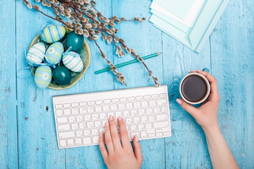 easter-in-the-office-workplace-on-blue-wooden-table